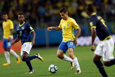 Brazil's Philippe Coutinho, center, runs with the ball as Ecuador's Juan Cazeres, left, looks on during a 2018 World Cup qualifying soccer match in Porto Alegre, Brazil, Thursday, Aug. 31, 2017. (AP Photo/Andre Penner)