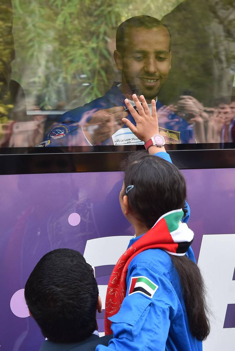 His sons and daughter shared a final moment together, pressing their hands against the class of the bus before the crew left for the launchpad. AFP