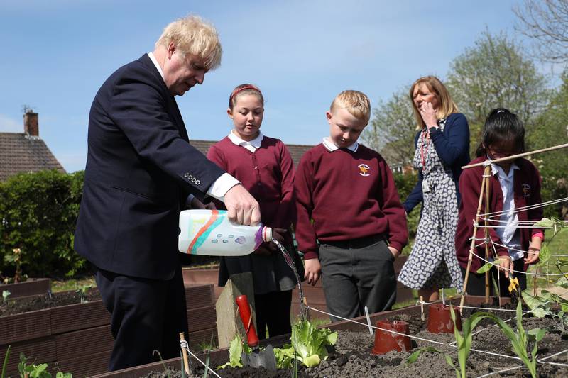 Boris Johnson Boris Johnson waters the vegetable garden. Getty Images
