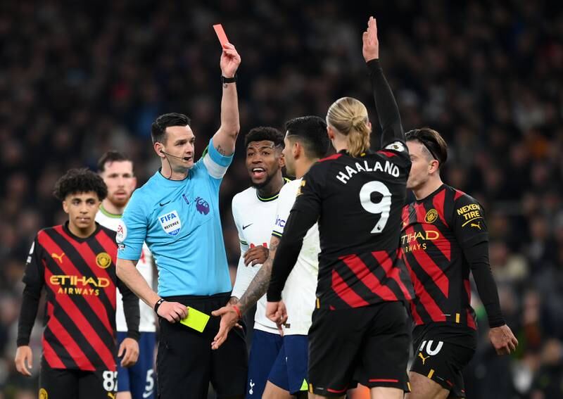 Referee Andy Madley shows a red card to Tottenham's Cristian Romero. Getty