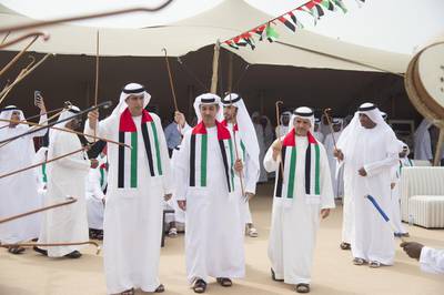 Jaber Al Suwaidi dances during the 44th National Day celebrations at the Crown Prince Court of Abu Dhabi. Seen with Ali Al Romaithi, and Saif Ali Al Qubaisi. Mohamed Al Suwaidi / Crown Prince Court - Abu Dhabi