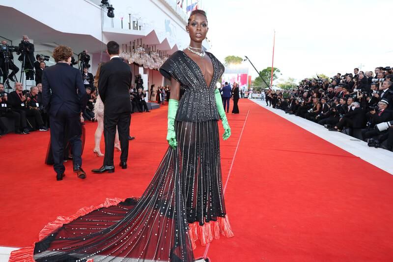 Jodie Turner-Smith in a black and silver sequinned Gucci dress with lime green satin gloves. Getty Images 