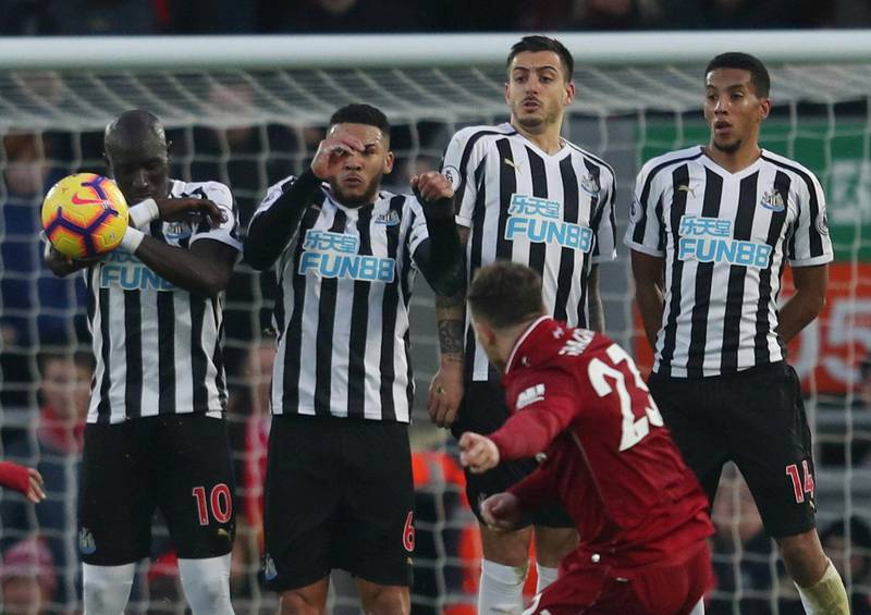 Shaqiri shoots at goal from a free kick as Newcastle United's Mohamed Diame, Jamaal Lascelles and teammates attempt to block. Action Images via Reuters