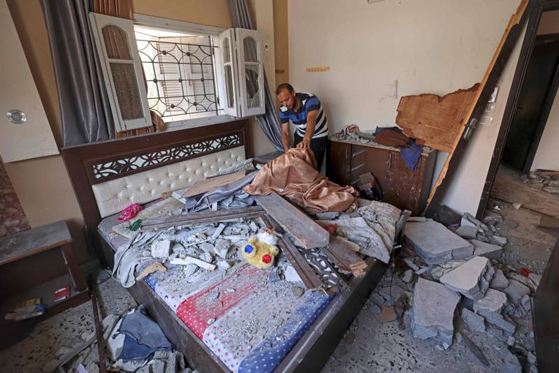 A Palestinian from the Shamalagh family inspects their damaged home in Gaza city early on Tuesday after a ceasefire between Israel and Palestinian militants came into force. AFP