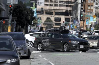 (FILES) In this file photo taken on March 27, 2017 an Uber self-driving car drives down 5th Street on March 28, 2017 in San Francisco, California. 
The race to perfect robot cars continues despite fears kindled by the death of a woman hit by a self-driving Uber vehicle while pushing a bicycle across an Arizona street. Uber put a temporary halt to its self-driving car program in the US after the fatal accident this month near Phoenix, where several other companies including Google-owned Waymo are testing such technology.
 / AFP PHOTO / Getty Images North America / JUSTIN SULLIVAN / 
With AFP Story by Ian TIMBERLAKE:  US-lifestyle-internet-automobile-Uber,foucs

