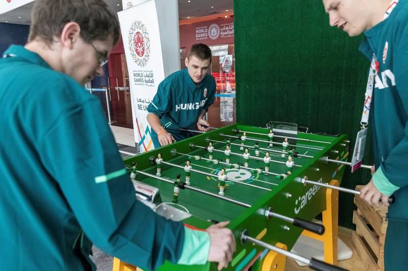 ABU DHABI, UNITED ARAB EMIRATES. 15 MARCH 2019. Special Olympics action at ADNEC. .Hungary team taking a break playing Foosball. (Photo: Antonie Robertson/The National) Journalist: None: National.