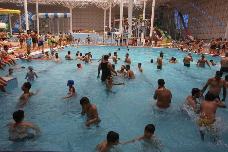 Iraqis gather at an indoor water park during a heatwave.