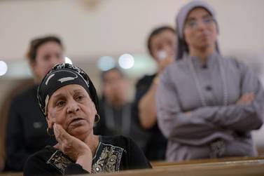 Egyptians attend mass at the St Mark Coptic Orthodox Cathedral in the Bani Mazar province, in the Minya governorate. Mohamed El Shahed / AFP