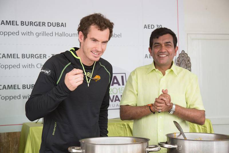 Andy Murray cooks with Sanjeev Kapoor, right, at this year's Beach Canteen in Dubai. Courtesy of Dubai Food Festival