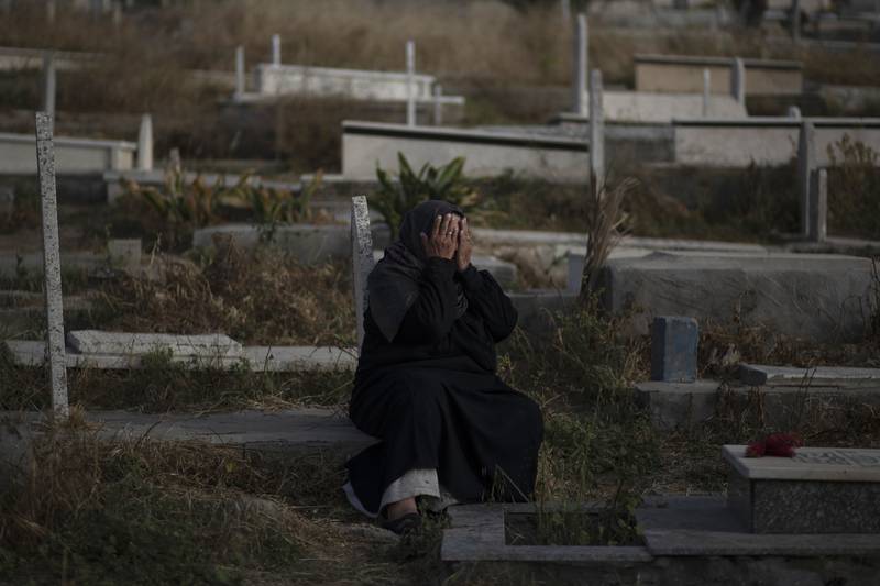 A Palestinian visits graves of deceased relatives during the first day of Eid al-Fitr holiday in Gaza City. AP