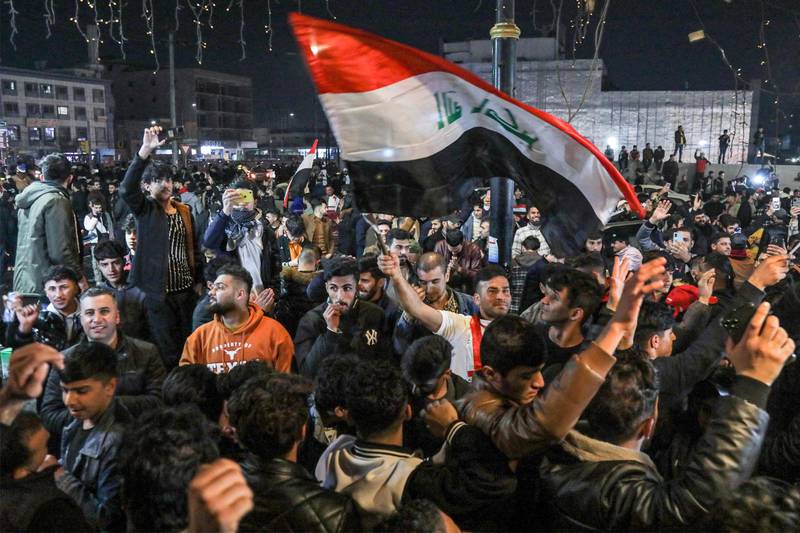 Iraqi football fans wave their national flag as they celebrate the team's victory against Oman in Arbil, the capital of Iraq's northern autonomous Kurdish region. AFP