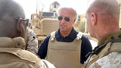 This 06 September, 2007 photo, courtesy of US Senator Joseph Biden's office, shows the Demoratic Delaware Senator(C) speaking with unidentified soldiers about the effectiveness and life-saving technology of the Mine Resistant Ambush Protected (MRAP) vehicle(rear) during a visit to Ramadi, Iraq. AFP PHOTO/HO/Courtesy of Senator Biden's office/RESTRICTED TO EDITORIAL USE/ GETTY OUT (Photo by HO / Joe Biden / AFP)
