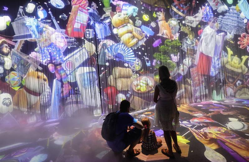 Visitors watch an animated wall inside the Japanese pavilion in Dubai. AFP