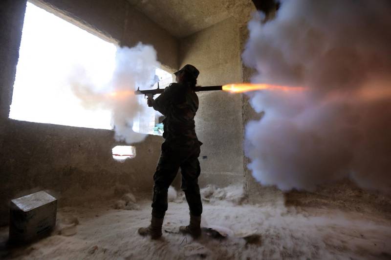 A female Syrian soldier from the Republican Guard commando battalion fires a rocket-propelled grenade (RPG) during clashes with rebels in the restive Jobar area, in eastern Damascus in 2015. AFP