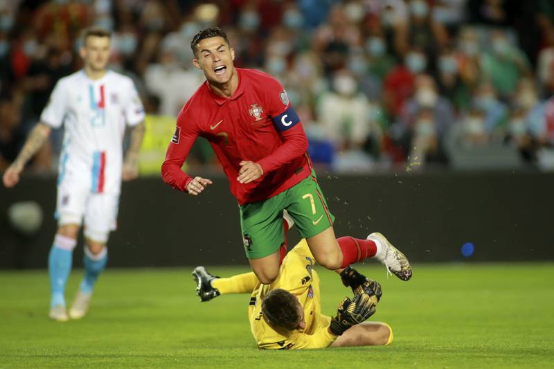 Luxembourg goalkeeper Anthony Moris fouls Portugal's Cristiano Ronaldo in the box to give away a penalty. AP Photo