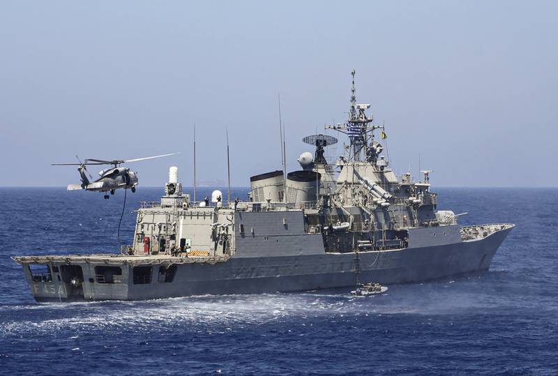 A handout photo released by the Greek National Defence Ministry on August 26, 2020 shows Greek Hydra-class frigate Psara (F-454) of the Hellenic Navy and a military helicopter taking part in a military exercise in the eastern Mediterranean Sea, on August 25, 2020. - Greece said it will launch military exercises on August 25 with France, Italy and Cyprus in the eastern Mediterranean, the focus of escalating tensions between Athens and Ankara. The joint exercises south of Cyprus and the Greek island of Crete will last three days, the defence ministry said. The discovery of major gas deposits in waters surrounding Crete and Cyprus has triggered a scramble for energy riches and revived old rivalries between NATO members Greece and Turkey. (Photo by Handout / GREEK DEFENCE MINISTRY / AFP) / RESTRICTED TO EDITORIAL USE - MANDATORY CREDIT "AFP PHOTO / GREEK DEFENCE MINISTRY" - NO MARKETING - NO ADVERTISING CAMPAIGNS - DISTRIBUTED AS A SERVICE TO CLIENTS