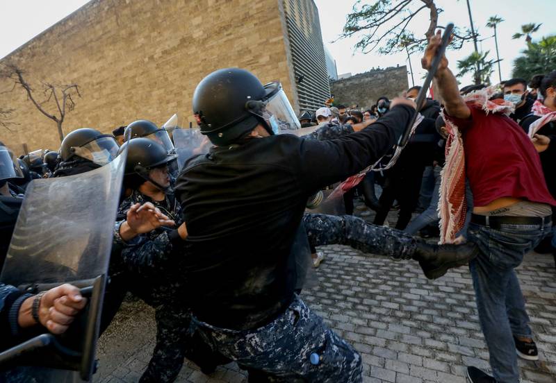 Lebanese policemen and students at the American University of Beirut (AUB) clash during a protest in front of the university over an effective tuition fee hike caused by the changing of the exchange rate from Lebanese lira to US dollar. EPA