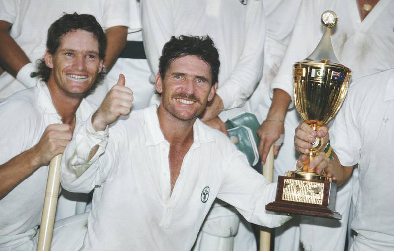 CALCUTTA, INDIA - NOVEMBER 08: Australia captain Allan Border holds the trophy as Dean Jones (l) looks on after Australia had beaten England by 7 runs to win the 1987 Cricket World Cup Final in Calcutta, India.  (Photo by Allsport/Getty Images)
