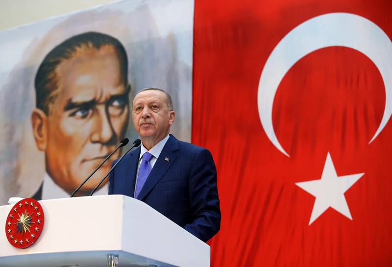 Turkey's President Recep Tayyip Erdogan, backdropped by a poster of modern Turkey's founder Mustafa Kemal Ataturk, speaks during a ceremony in Istanbul, Saturday, Oct. 26, 2019. (Presidential Press Service via AP, Pool)