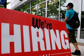 A "now hiring" sign posted outside of a restaurant in Arlington, Virginia, on June 3, 2022.  AFP