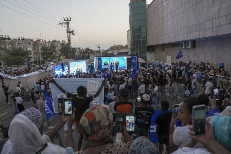 Former Israeli prime minister Benjamin Netanyahu delivers an election campaign speech from inside a modified delivery lorry, with a side wall replaced with bulletproof glass, in Beersheba, on Tuesday. AP