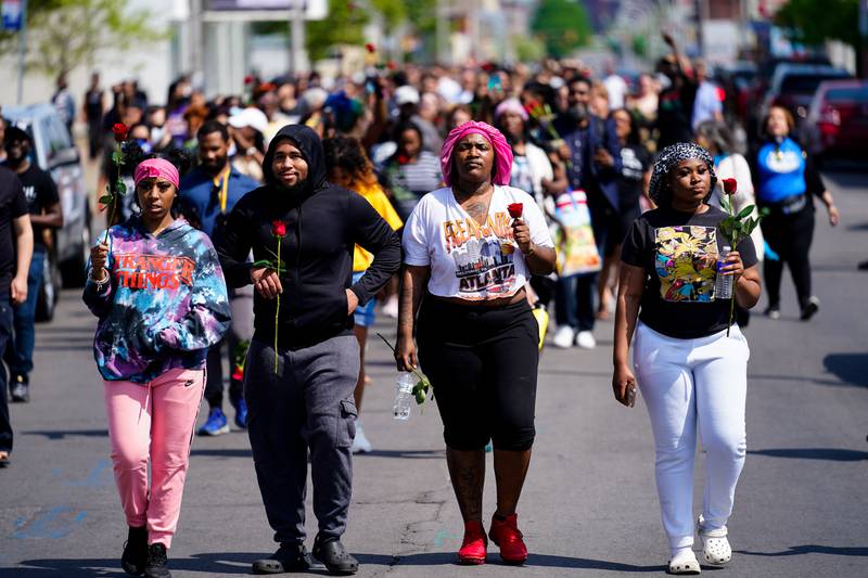 People march to the scene of the shooting in Buffalo. AP