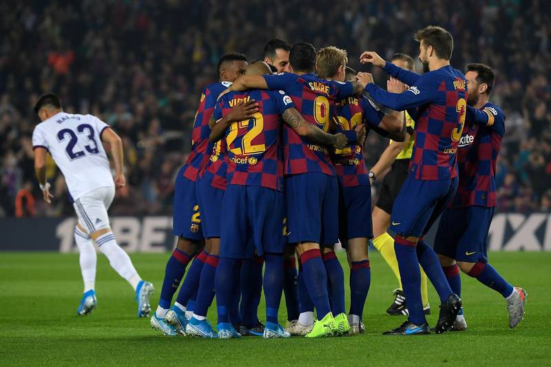 Barcelona's players congratulate French defender Clement Lenglet for scoring the opening goal against Real Valladolid at the Camp Nou stadium in Barcelona on October 29, 2019. / AFP / LLUIS GENE