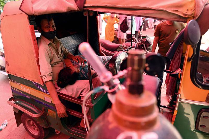 A patient breathes with the help of an oxygen cylinder provided by a gurdwara, a place of worship for Sikhs, inside an autorickshaw amid the Covid-19 pandemic in the northern Indian city of Ghaziabad. AFP