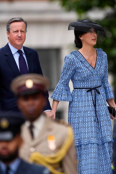 Former prime minister David Cameron and his wife Samantha Cameron, wearing one of her own Cefinn designs. PA