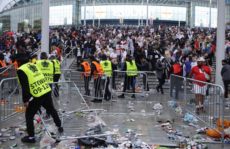 Stewards replace barricades outside Wembley Stadium in London, during the Euro 2020 final between England and Italy, outside which 6,000 people without tickets were planning to storm the stadium. AP
