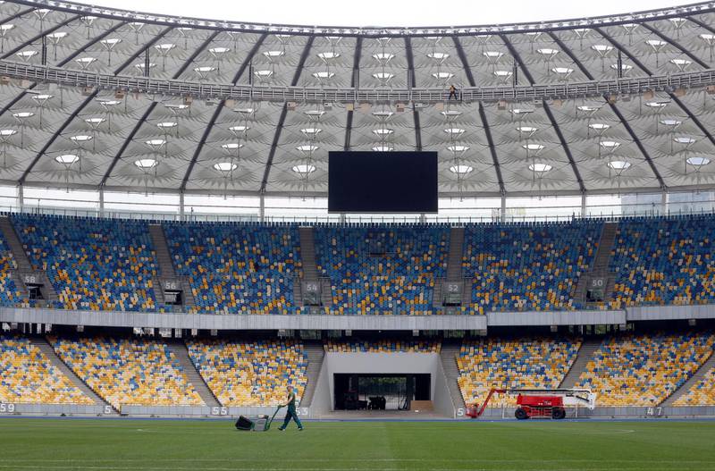 A groundsman cares for the grass inside the NSC Olimpiyskiy Stadium in Kiev, on May 14, 2018, ahead of the 2018 UEFA Champions League Final football match between Liverpool and Real Madrid. Efrem Lukatsky / AP Photo
