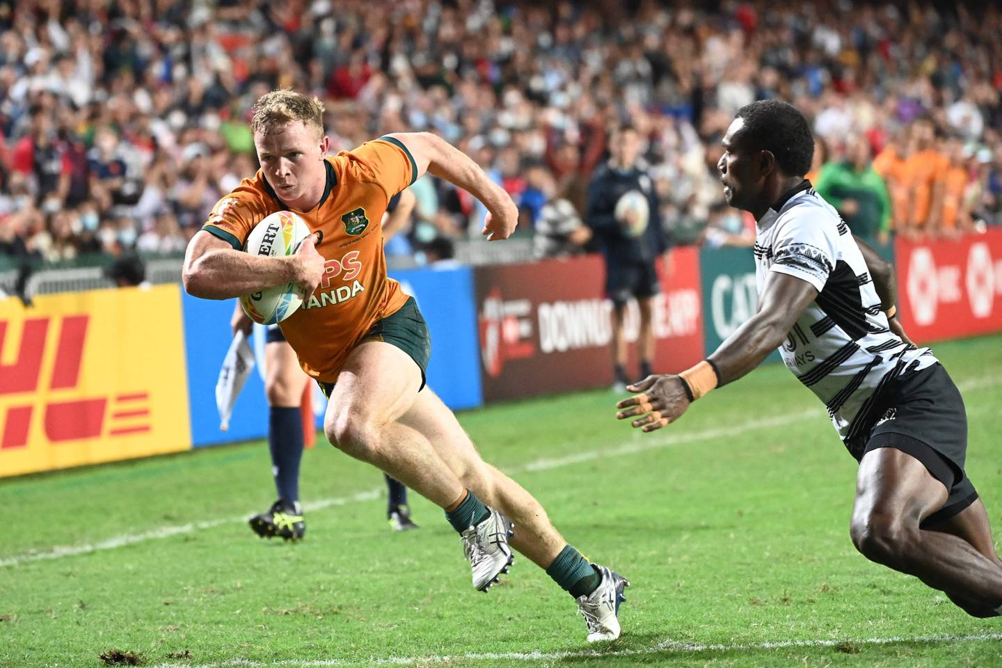 Australia’s Henry Hutchison, left, heads for a try as Fiji’s Josevani Soro attempts a tackle in the Hong Kong Sevens men's final on November 6, 2022. AFP