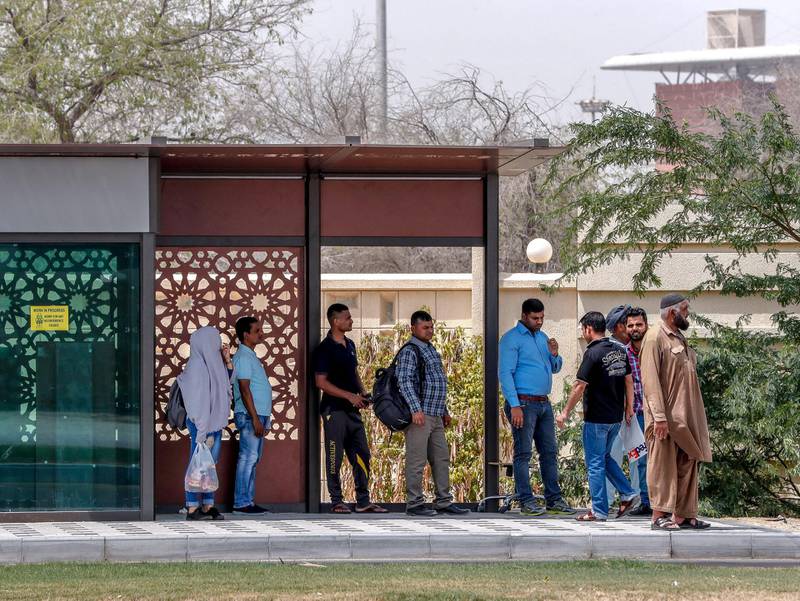 Abu Dhabi, U.A.E., July 11, 2018.  Stock photos of transportation - public buses, bus waiting sheds, taxis, passengers, bus ticket machines, mawaqif.  Commuters wait for the bus at the Saif Ghubash Street bus stop.Victor Besa / The NationalSection: NAReporter: