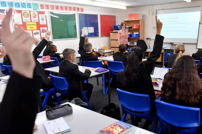 Pupils raise their hands in a lesson as they return to school at Copley Academy on September 09, 2021 in Stalybridge, England. Getty