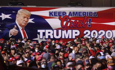 A bus with an image of US President Donald Trump sits next to the crowd during a campaign rally at Richard B. Russell Airport in Rome, Georgia. AFP