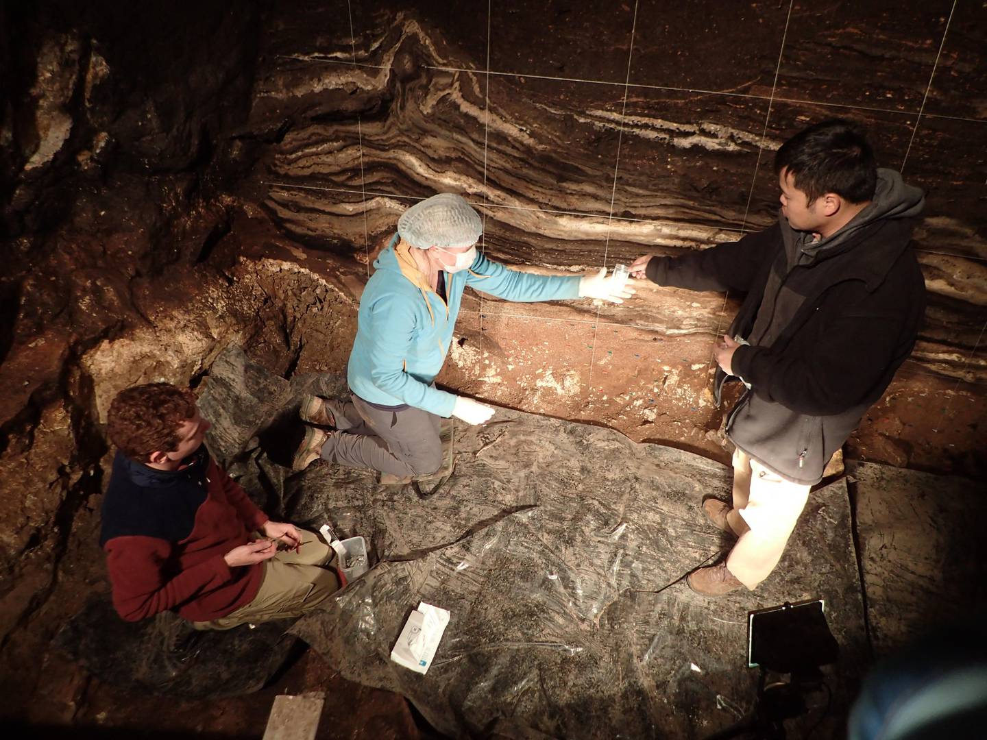 Scientists collecting sediment samples in the South Chamber at the Denisova Cave in the Altai mountains, Siberia. AFP
