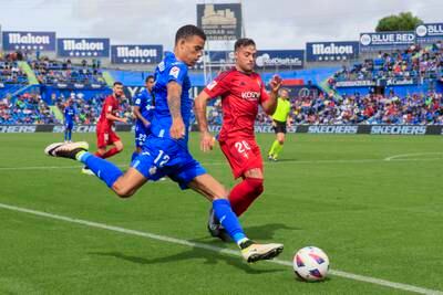 Getafe striker Mason Greenwood in action against Osasuna midfielder Jose Arnaiz. EPA