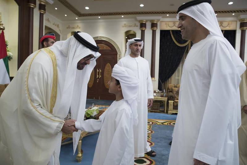 Sheikh Mohammed bin Zayed greets a young guest during an Eid Al Fitr reception at Mushrif Palace. Mohamed Al Hammadi / Crown Prince Court - Abu Dhabi