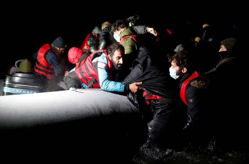 Migrants board an inflatable dinghy as they leave the coast of northern France to cross the English Channel. Reuters