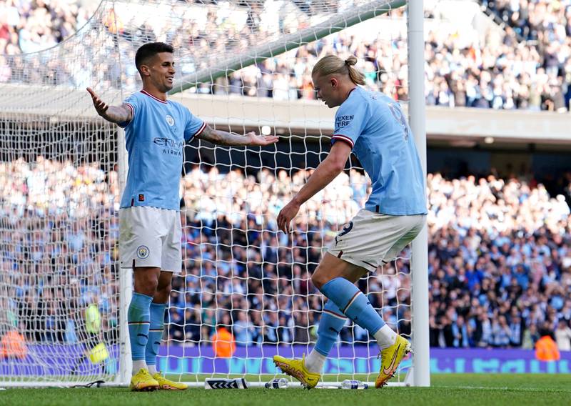 Manchester City's Erling Haaland celebrates with teammate Joao Cancelo after scoring against Southampton. PA