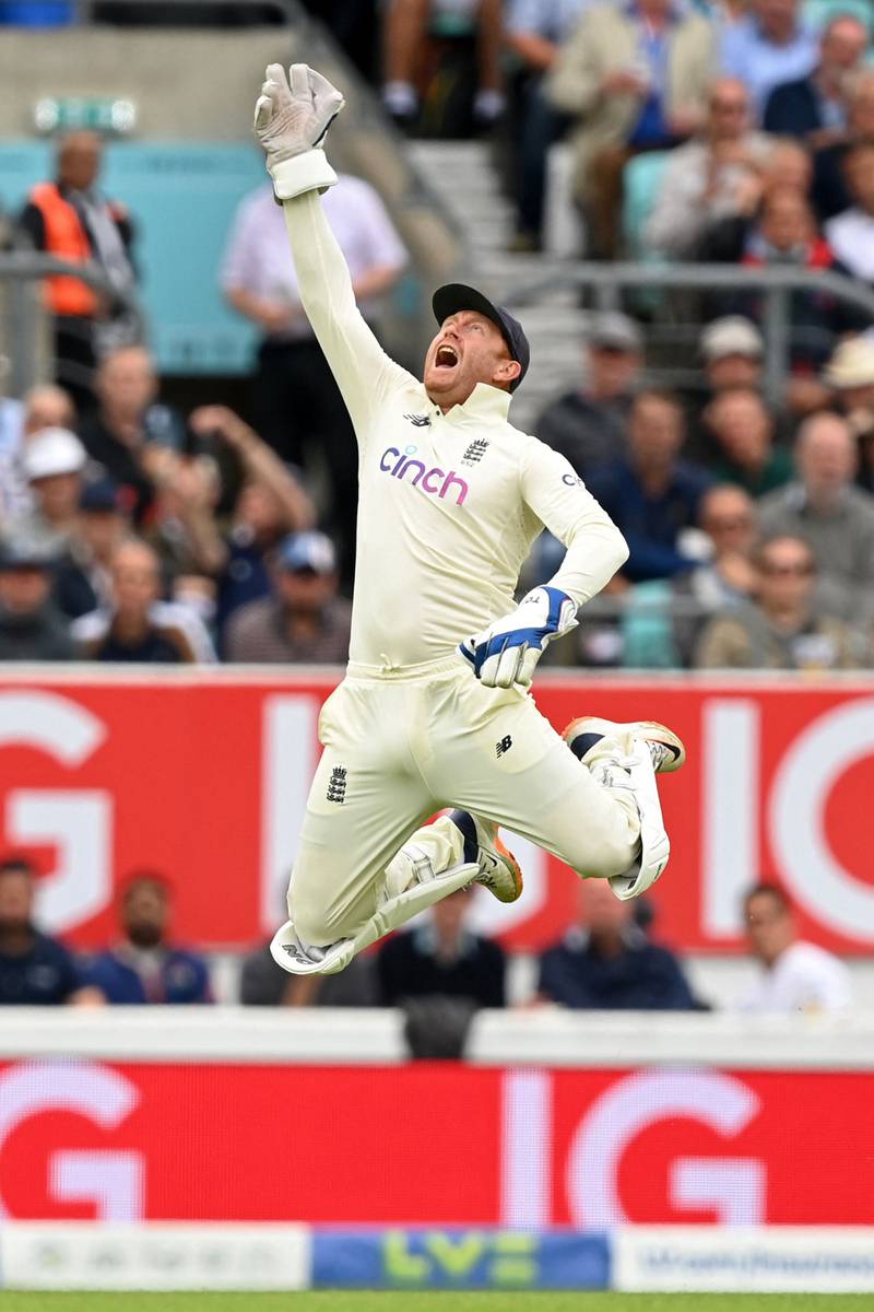 England wicketkeeper Jonny Bairstow celebrates after taking a catch to dismiss India's Cheteshwar Pujara. AFP
