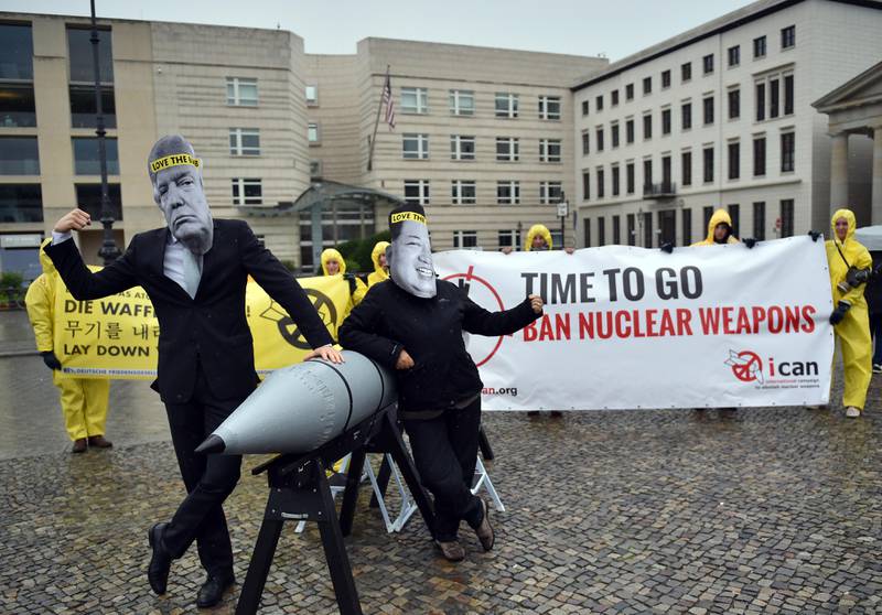 FILE - in this Sept. 13, 2017 file photo activists of the International Campaign to Abolish Nuclear Weapons (ICAN) protest against the conflict between North Korea and the USA with masks of the North Korean ruler Kim Jong Un, right, and the US president Donald Trump, left,  in front of the US embassy in Berlin, Germany. The International Campaign to Abolish Nuclear Weapons wins the Nobel Peace Prize. The Norwegian Nobel Committee honored the Geneva-based group "for its work to draw attention to the catastrophic humanitarian consequences of any use of nuclear weapons and for its ground-breaking efforts to achieve a treaty-based prohibition of such weapons." (Britta Pedersen/dpa via AP)