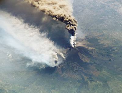 SICILY, ITALY - OCTOBER 30:  (FILE IMAGE)  This image, taken from cameras onboard the International Space Station, shows plumes of smoke and ash erupting from Mount Etna on October 30, 2002 in Sicily, Italy. The image looks as if it were taken by a high altitude aircraft, but in fact it was taken with a high magnification lens from space. (Photo by ISS/NASA/Getty Images)