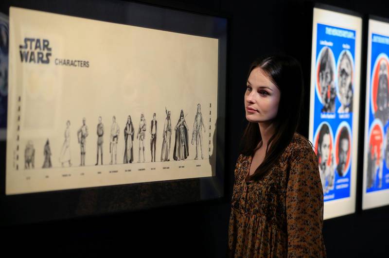 A Sotheby's employee looks at "The Empire Strikes Back" character size chart from 1978, estimated at £10,000-£15,000, from the archive of Roger Nichols, who was the special effects designer for the film during a photocall at Sotheby's in London, Britain. Reuters