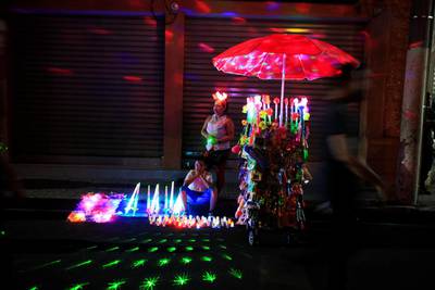 A woman and her son sell toys during the Lantern Festival celebrating the eve of the nativity of the Virgin Mary in Ahuchapan, El Salvador. Jose Cabezas / Reuters