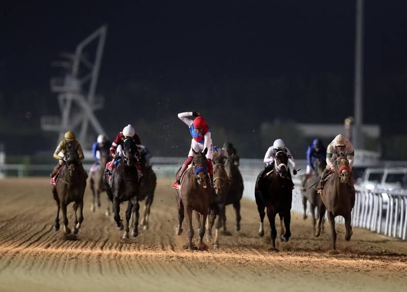 Country Grammer ridden by Frankie Dettori wins the Dubai World Cup at Meydan racecourse in Dubai. Chris Whiteoak / The National