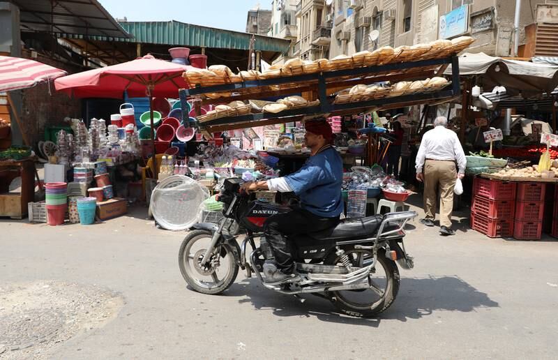 An Egyptian man carries a rack full of bread in the Abdeen district of Cairo, Egypt. EPA