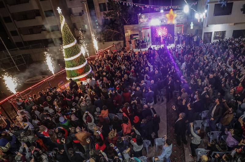epa08042110 Palestinians attend the ceremony of lighting a Christmas tree in Gaza City, 03 December 2019. The event was organised by the YMCA Gaza.  EPA/MOHAMMED SABER