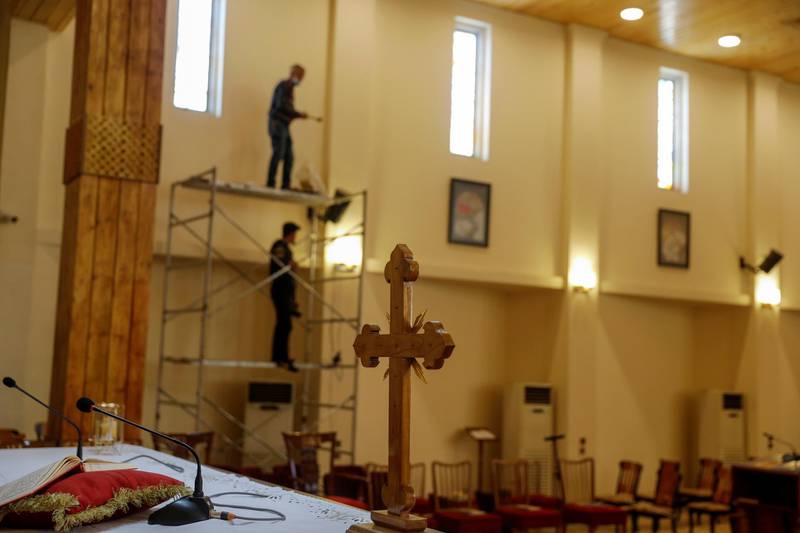 Workers at St Joseph Chaldean Cathedral. The visit from March 5 to 8 will be the first trip abroad by Pope Francis since the outbreak of the coronavirus pandemic. Reuters