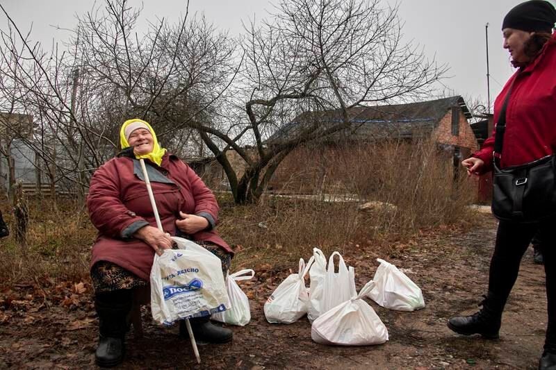 Volunteers distribute humanitarian aid to residents on the outskirts of Kharkiv, Ukraine, on December 16. EPA
